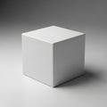 A white cube sitting on a gray surface Royalty Free Stock Photo