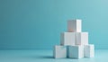 White cubes stacked in pyramid shape on blue background. Seven white blocks arranged in geometric form. Modern still life Royalty Free Stock Photo