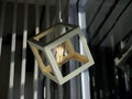 White cubic frame hanging with a light bulb.