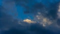 White cumulus cloud among dark rain clouds Royalty Free Stock Photo