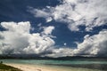 White cumulus clouds against blue sky over turquoise sea water Royalty Free Stock Photo