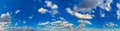 Ultra wide panorama of blue clear sky with gorgeous white clouds illuminated by the sun Royalty Free Stock Photo