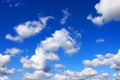 White cumulus clouds and blue sky.