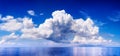 White cumulus clouds in blue sky over sea landscape, big cloud above ocean water panorama, seascape panoramic view, cloudy weather Royalty Free Stock Photo