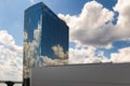 White cumulus clouds and blue sky reflection in the glass walls of a skyscraper Royalty Free Stock Photo