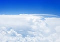 White cumulus clouds on clear blue sky background, aerial cloudscape panoramic view from airplane, high azure skies panorama Royalty Free Stock Photo