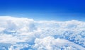 White cumulus clouds on clear blue sky background, aerial cloudscape panoramic view from airplane, high azure skies panorama Royalty Free Stock Photo