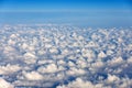 White cumulus clouds on clear blue sky background from a flying plane Royalty Free Stock Photo