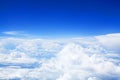 White cumulus clouds clear blue sky background, scenic aerial cloudscape view from airplane, high azure skies backdrop Royalty Free Stock Photo