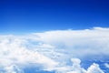 White cumulus clouds clear blue sky background, scenic aerial cloudscape view from airplane, high azure skies backdrop Royalty Free Stock Photo