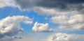 White cumulus clouds among dark rain clouds Royalty Free Stock Photo