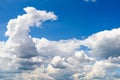 White Cumulus Clouds And Grey Storm Clouds On Blue Sky