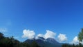 White cumulus clouds in the sky over mountains, landscape Royalty Free Stock Photo