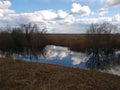 White cumulus clouds in sky over river landscape. Royalty Free Stock Photo