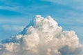 White cumulus congestus clouds on blue sky background.