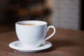 White cup of aromatic coffee on a wooden table Royalty Free Stock Photo