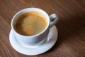 White cup of aromatic coffee on a wooden table Royalty Free Stock Photo