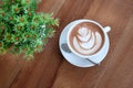 A white cup of beautiful hot cocoa on wooden table