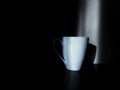 white cup on black background