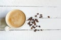 White cup of Black coffe with coffe beans and Copy Space on white wooden background Royalty Free Stock Photo