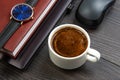 white cup of black coffee on the office table next to the laptop and business items. business and breakfast time Royalty Free Stock Photo