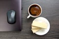 white cup of black coffee on the office table next to the laptop and business items. business and breakfast time Royalty Free Stock Photo