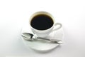 White cup of black coffee and a spoon on a white background Royalty Free Stock Photo