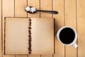 White cup with black coffee on a wooden table. Grains of coffee on an old book Royalty Free Stock Photo