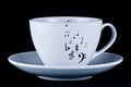 White cup with black musical notes