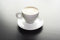 White cup of cappuccino on a black matte surface Royalty Free Stock Photo