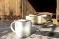 White cup with cappuccino coffee and books on an old table Royalty Free Stock Photo