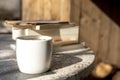 White cup with cappuccino coffee and books on an vintage table with a background of old rustic woods Royalty Free Stock Photo