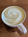 White cup of Cappuccino with swirl in foam Royalty Free Stock Photo