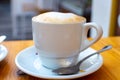 White cup with cappucino coffee with whipped hot milk Royalty Free Stock Photo