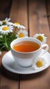 White cup with chamomile tea on a wooden table. There are chamomile flowers nearby. Copy space, place for text, empty Royalty Free Stock Photo