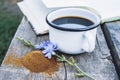 White cup with chicory drink and flowers near chicory powder. Tea from chicory. Healthy eating concept Royalty Free Stock Photo