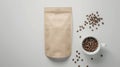 White cup with coffee beans and craft paper mockup bag, top view for enticing presentation Royalty Free Stock Photo