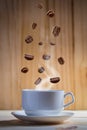 White cup coffee beans with falling beans Royalty Free Stock Photo