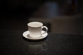 White cup of coffee on a black background. Mockup