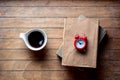 White cup with coffee and books with alarm clock Royalty Free Stock Photo