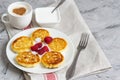 White Cup of Coffee Cappuccino with Heart Pattern of Cinnamon, Cottage Cheese Pancakes with Raspberries