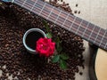 White cup of coffee, with coffee beans backgound and red rose, g Royalty Free Stock Photo