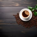 White Cup of Coffee with Fresh Green Leaves and Beans on a Dark Wooden Background Royalty Free Stock Photo