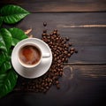 White Cup of Coffee with Fresh Green Leaves and Beans on a Dark Wooden Background Royalty Free Stock Photo