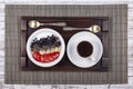 White cup of coffee and healthy muesli made from strawberry, blueberry, chia seeds, oat flakes with yogurt on a tray on white wood Royalty Free Stock Photo