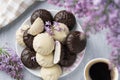 Cup of coffee, lilac, marshmallow in dark and white chocolate glaze. Sweet dessert in morning