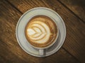 White cup with coffee on the old wooden table in the cafe Royalty Free Stock Photo