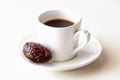 White cup of coffee and one dates white background isolated