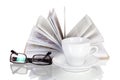 White cup of coffee, open book and glasses Royalty Free Stock Photo