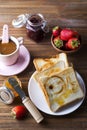 A white cup of coffee with Sandwiches or toasts with apricot jelly or jam on wooden table, Royalty Free Stock Photo